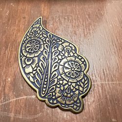 Bronze Raised Design Brooch Pin On Black Paisley Shape 3 3/4” Floral Design