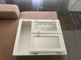 White wooden wall cabinet with glass panels