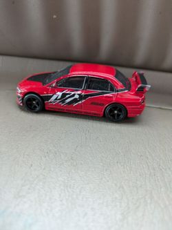 Yoshi super Mario Bros race car and  Hot Wheels Fast & Furious Mitsubishi Lancer Evolution IX