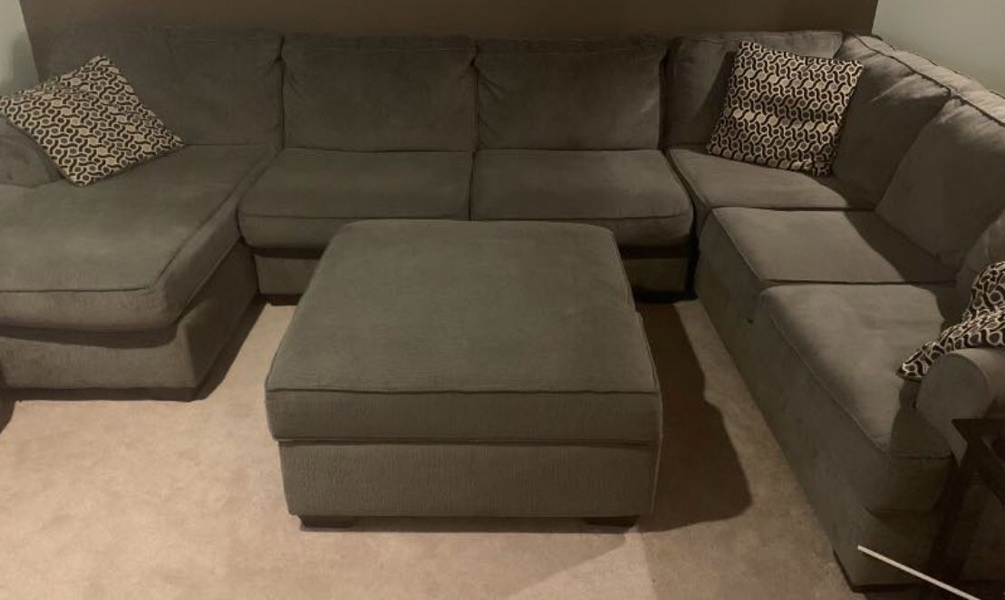 Grey sectional couch and storage ottoman