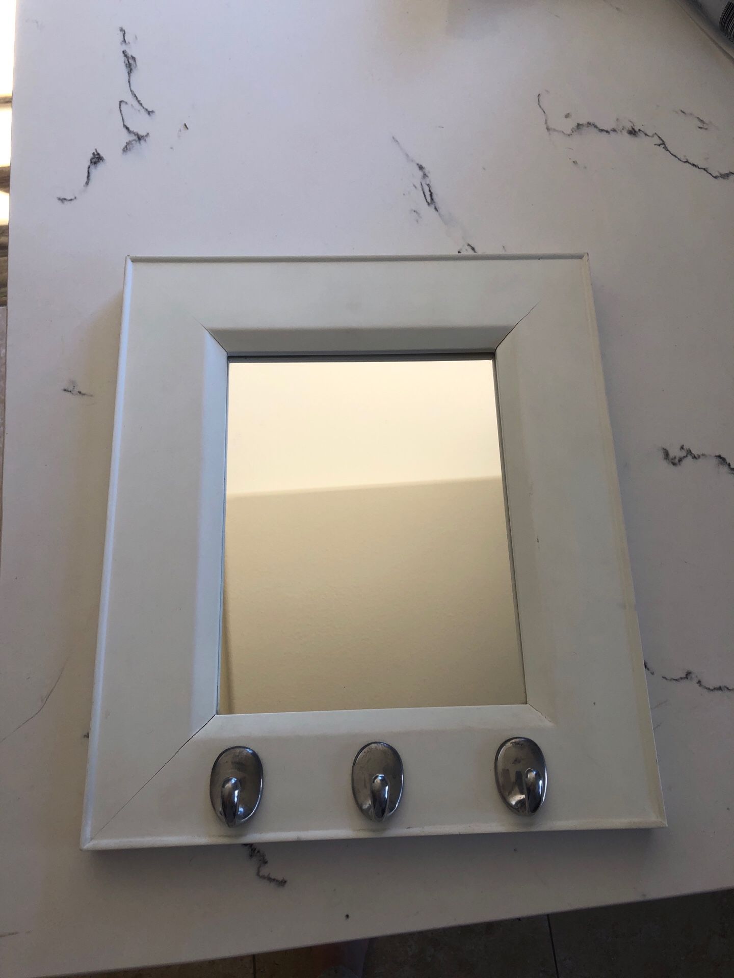 Small mirror with hooks