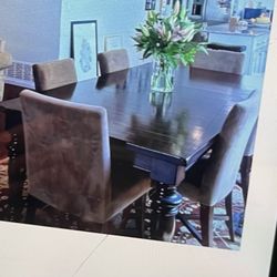 Dark brown wood dining table, extendable with 8 chairs
