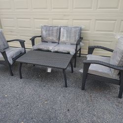 Outdoor patio wicker couch with chairs and coffee table 