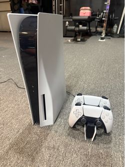PlayStation 5 with 2 DualSense controllers and charging station
