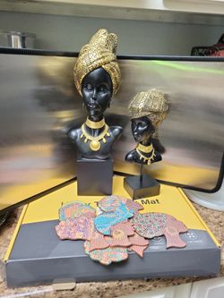 Bundle two African female bust statues with coasters..