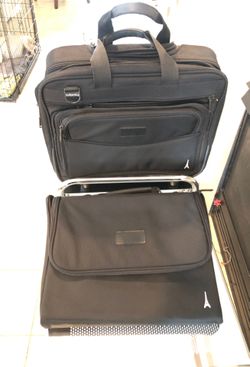 Computer roller bag and laptop carrier pocket.