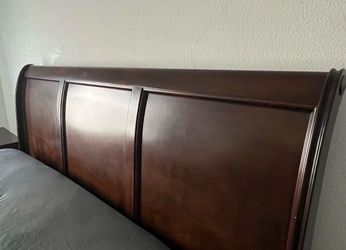 King size bed with dresser and two side tables.