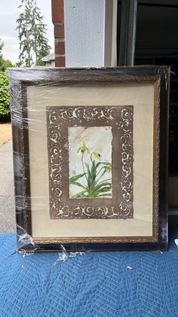 The image shows a framed botanical art print or watercolor painting depicting lady's slipper orchids (Cypripedium