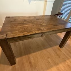 Wood dining table sits 6