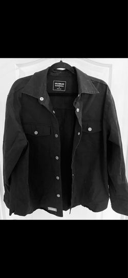 black Unlabeled brand jacket features prominent silver-toned button fastenings and two chest pockets
