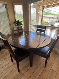 Kitchen table approximately 52 inches round fold into a square as well