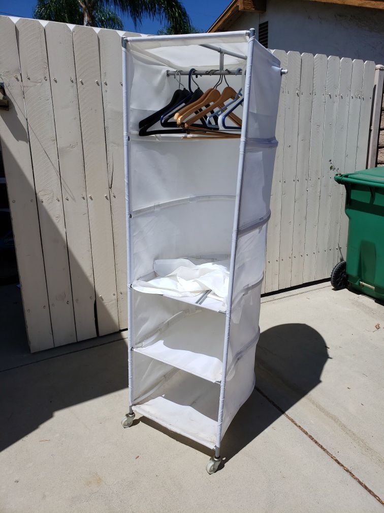 Portable closet. Use in garage or room to hang clothes. Add shelves. On wheels. East to move. $20. Call Bruce {contact info removed}