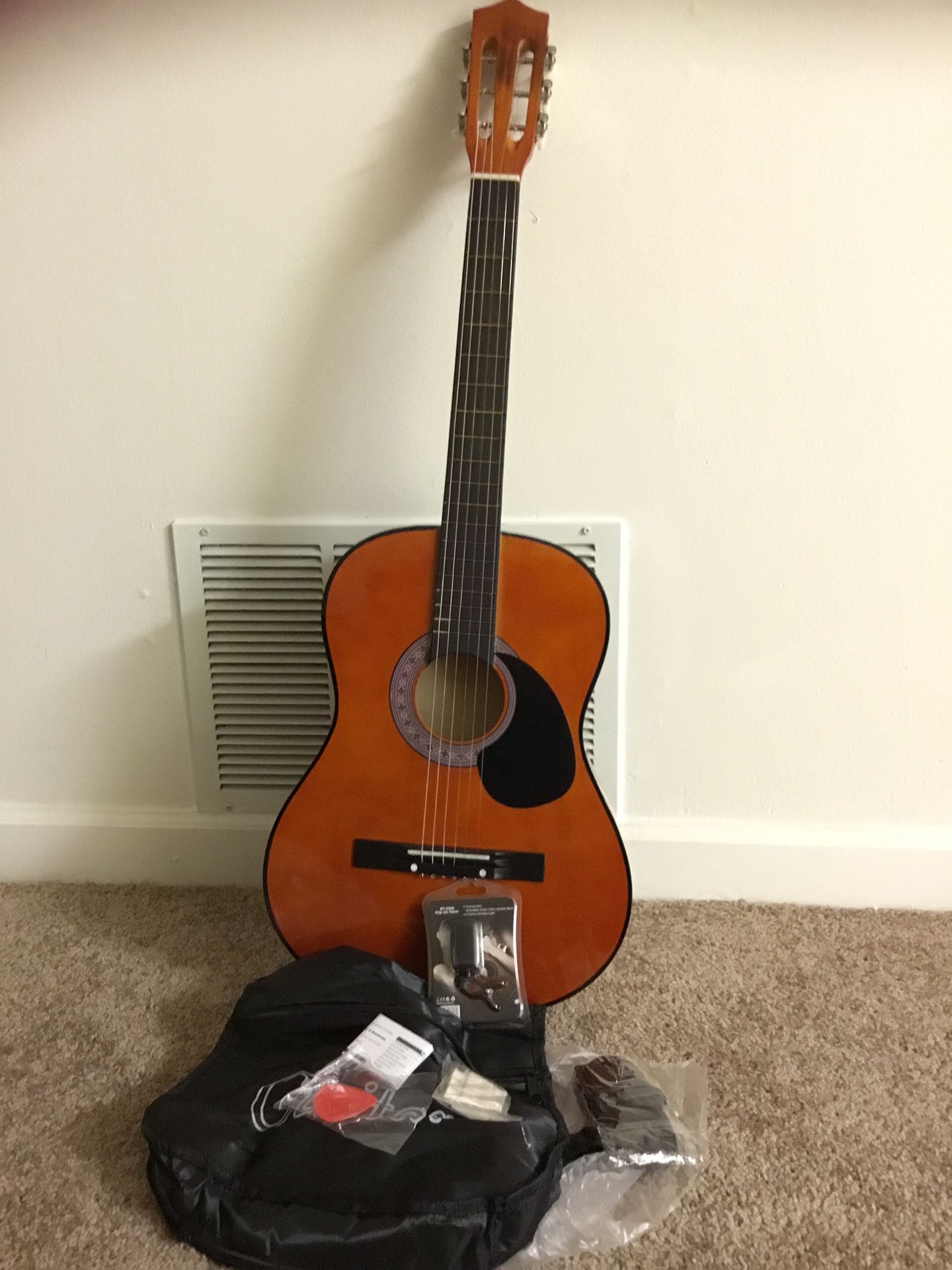 Guitar with bag, pick, pitch pipe, and brand new clip-on tuner!