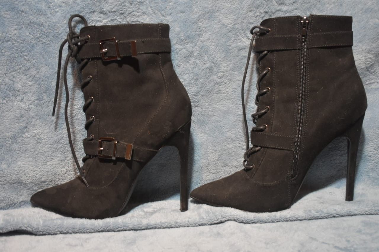 Black suede, calf high boots.