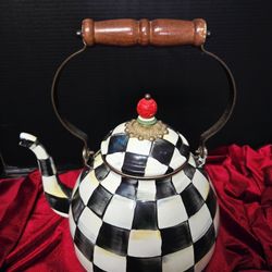 MacKenzie-Childs Courtly Check enamel tea kettle featuring a signature hand-painted black-and-white checkered pattern. 