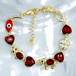 Good Luck Bracelet with Red Crystal Hearts, Gold-Tone Finish, and Decorative Elements
