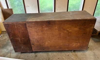 Vintage wood storage box on wheels.