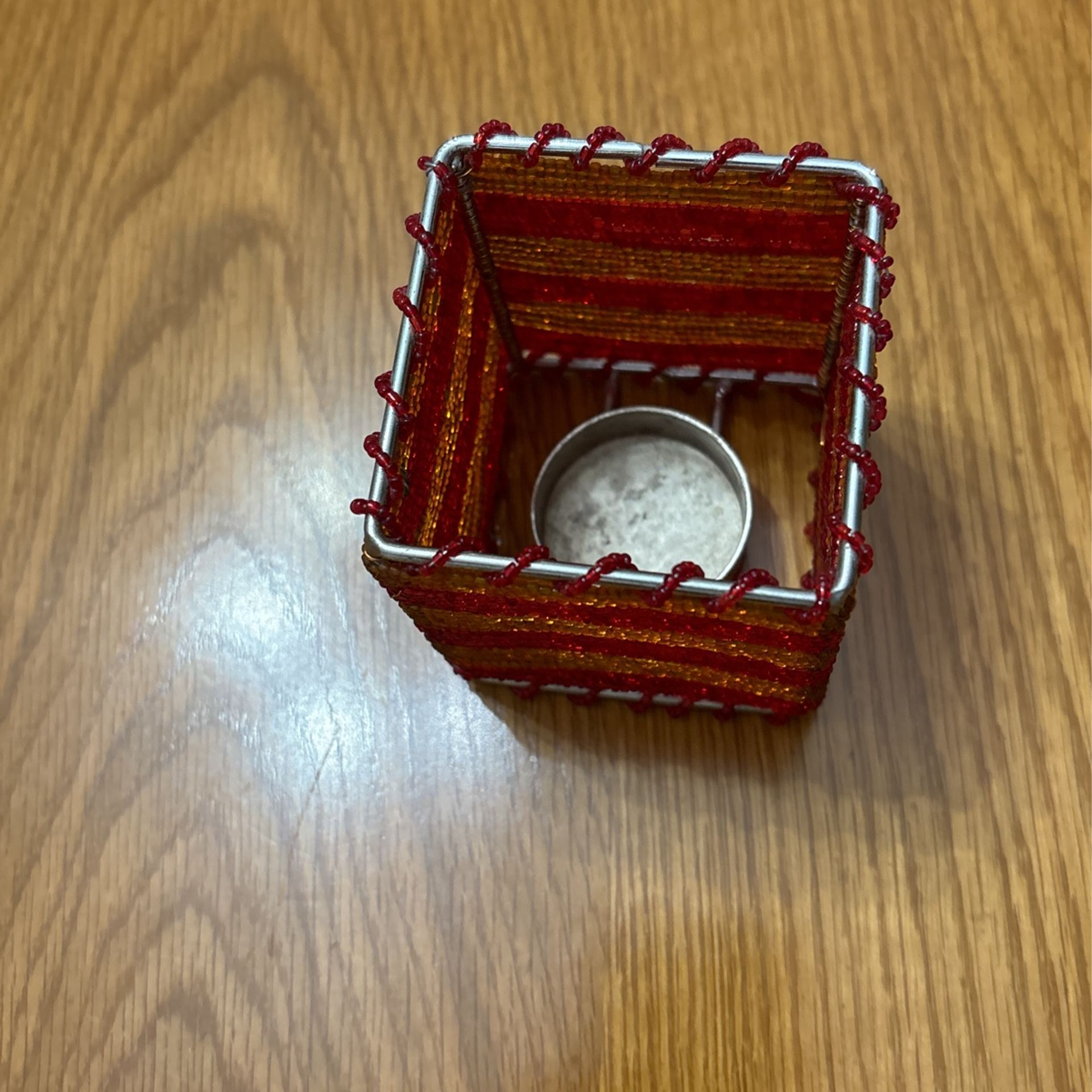 Gold and red tea candle holder.