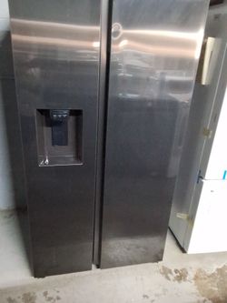 Samsung side by side refrigerator with Ice and water dispenser.  (New open box scratchn dent)