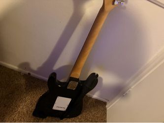 Black and white electric guitar, works well