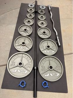 Cap complete Olympic weights set with bars and clips.  Includes bar curl bar clips  over 300 pounds all together  pairs of 45-35-25-10 2 pairs of 5s a