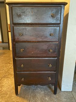 Antique wooden chest of drawers with glass knobs