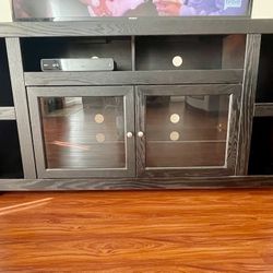 For Sale - Black 65” TV Console With Glass Doors And Shelves 