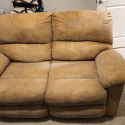 Loveseat With Black Cover And Pillows.