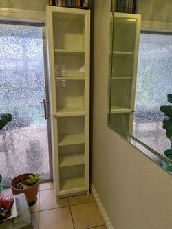 2 white Ikea Billy book cases with glass front
