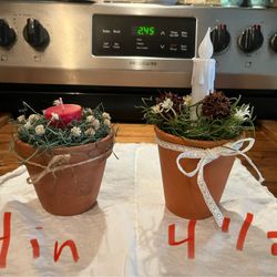 Terra-Cotta Pot Decorated With Flowers And Candles
