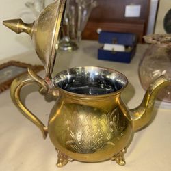 Vintage etched brass teapot with pineapple and floral motifs.