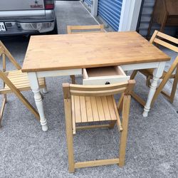 Table with 4 foldable chairs   $120