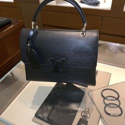 USED BLACK LOUIE VUITTON BAG WITH MATCHING BIG WALLET.