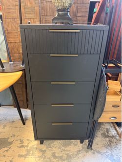 dark gray Granville 5-drawer dresser features vertical fluted detailing on the top drawer and sleek horizontal gold handles - 24” x 20” x 49”
