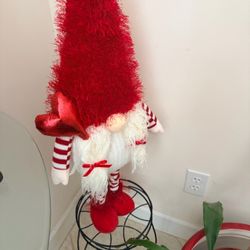 30 inch large gnome in perfect condition, red feathered hat and boots with long white pigtails with red bows and striped arms and striped feet