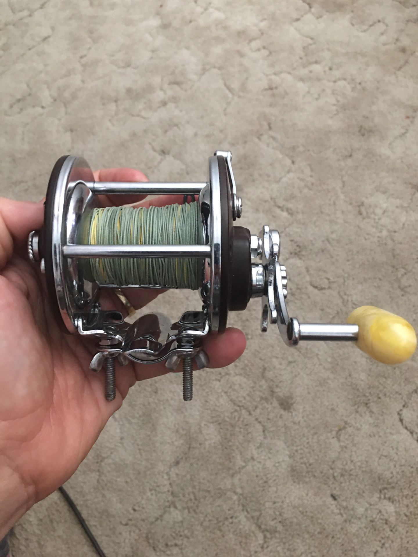 Penn 209 fishing reel with the heavy duty pole mounting bracket ( they use on most deep sea fishing poles)