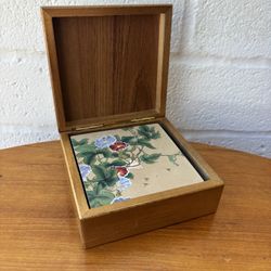 Vintage Japanese-style coaster set featuring floral designs, housed in a wooden box