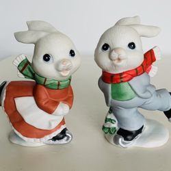 Vintage Homco christmas Ice skating Bunnies set of two. Porcelain/ceramic bisque. No chips cracks or damage. Paint Colors are bright. 4” tall.  