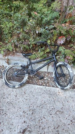 Kids BMX bike, it is painted Matt black. And it has camo wheels. And it is great for beginners.