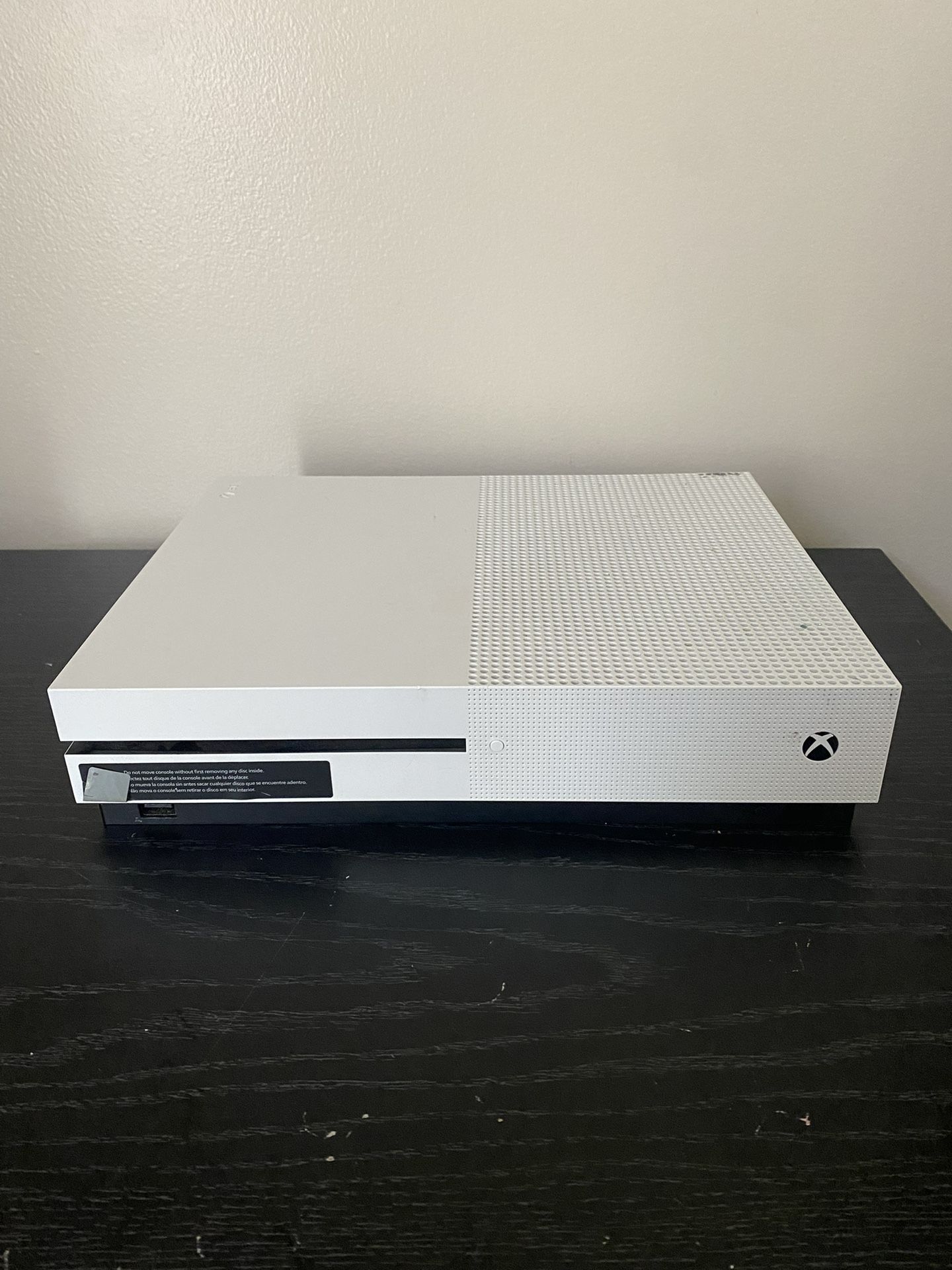 X box one S with two controllers and a headset