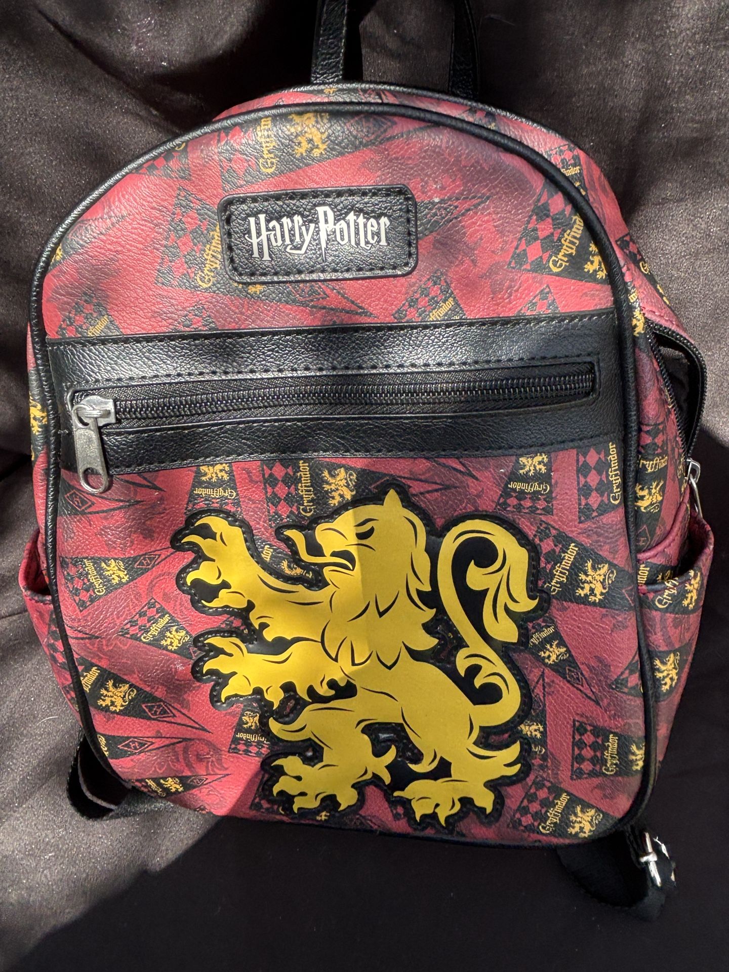 This is a Harry Potter - Loungefly - Gryffindor - Mini Backpack.  Red and black with a yellow lion