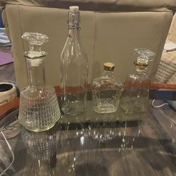 A Lot Of Bottles And Empty Liquor Decanter With Stoppers. Clear Glass Vintage..
