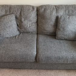 Two Gray Couches with Four Pillows