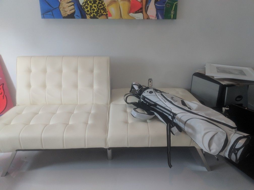 Futon white and like new leatherette matirial modern and comfertable for a futon!