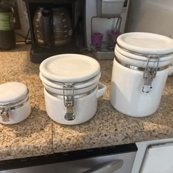Set of white ceramic canisters with latching lids