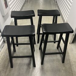 Four wood black stools