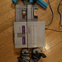 Super Nintendo with Two Controllers And Two Games 