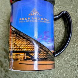 souvenir ceramic coffee mug featuring the Rock & Roll Hall of Fame & Museum in Cleveland, Ohio. 