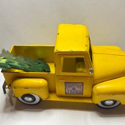 Vintage decorative metal model of a yellow pickup truck