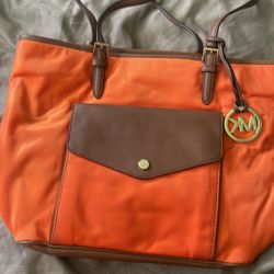 Michael Kors, orange and brown purse great condition